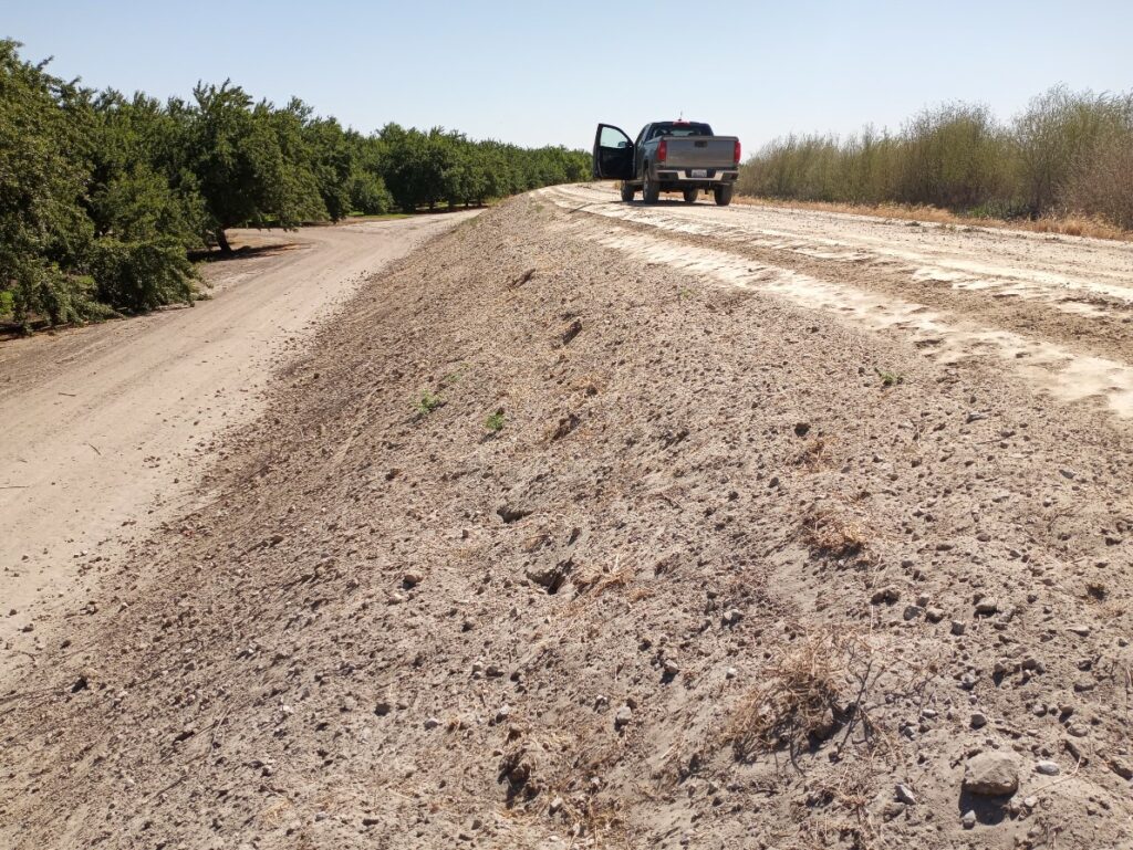 Truck on top of earthen levee.