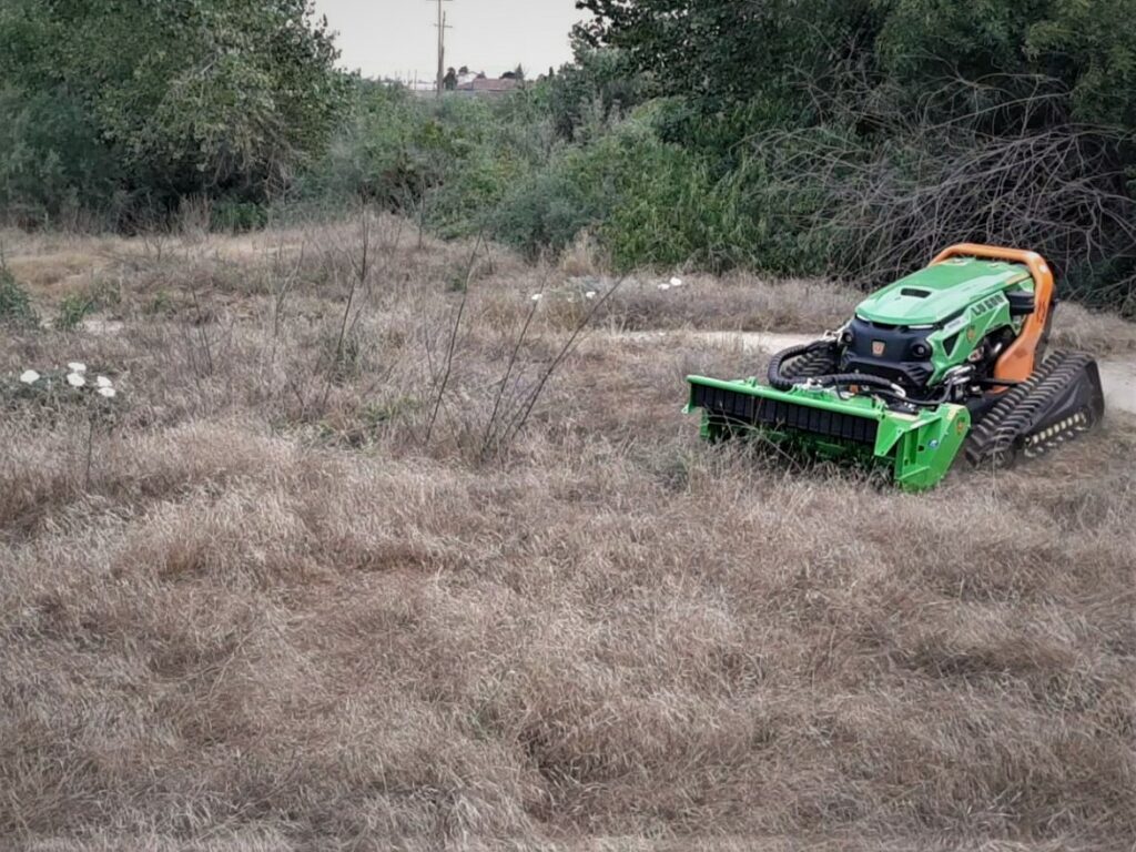 Automatic mower in a field of native vegetation.